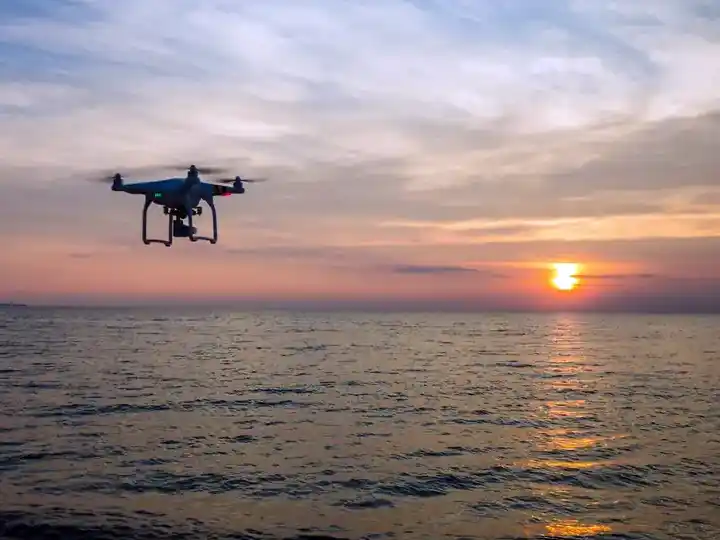 Drone flying over the ocean capturing stunning sunset views at Danglai Resort in Semporna