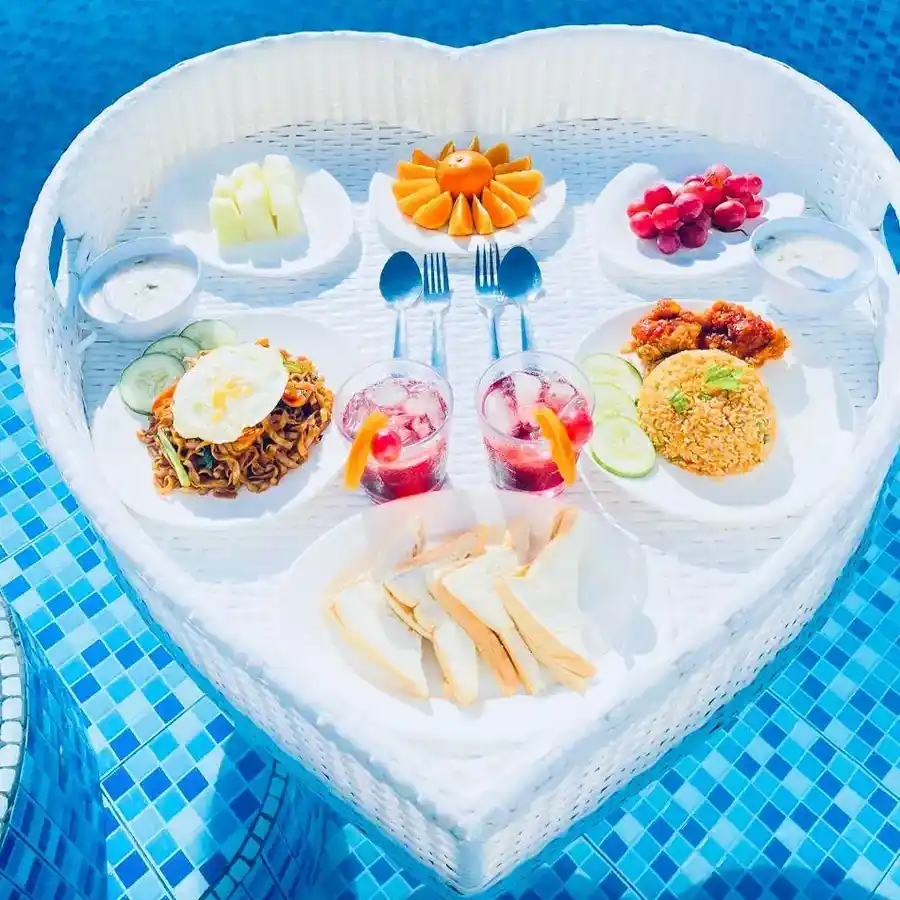 Romantic floating breakfast in a heart-shaped tray served in a private plunge pool at Danglai Resort, Semporna